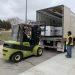 Workers loading helmets and ballistic vests headed to Ukraine into a truck at Camp Dodge in Johnston, Iowa.