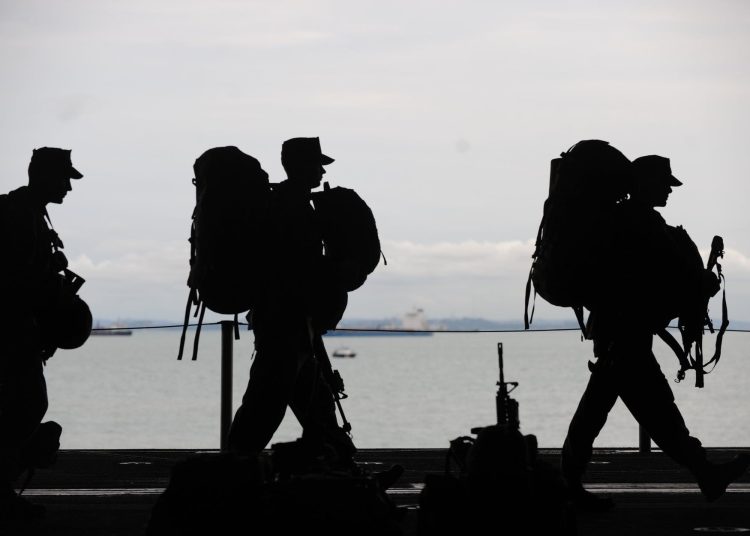 silhouette of soldiers walking