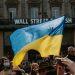 blue and yellow ukrainian flag waving above crowd of people