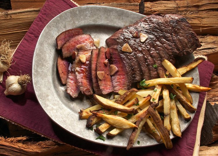 photo of steak and french fries on gray plate