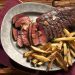 photo of steak and french fries on gray plate