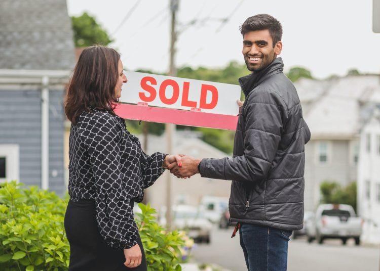 a man in black jacket having a deal with the agent