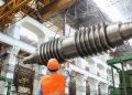 man standing beside heavy equipment