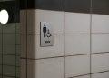 white tiled wall with men s restroom sign