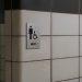 white tiled wall with men s restroom sign