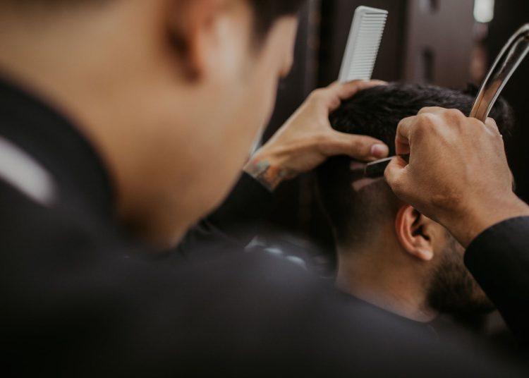 selective focus photography of a barber