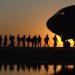 soldiers in line to get in a plane