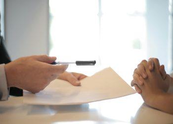 crop businessman giving contract to woman to sign