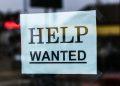 help wanted sign on glass