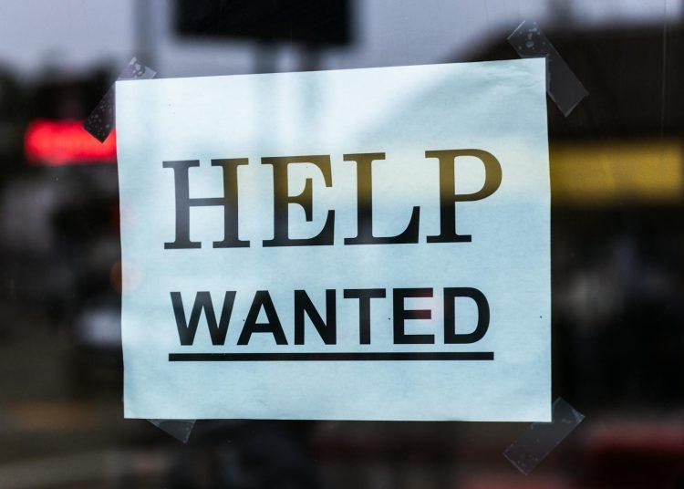 help wanted sign on glass